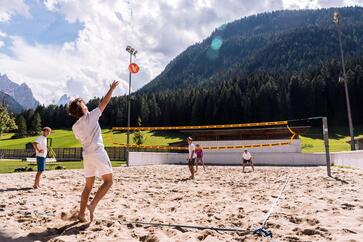 Eine Gruppe von Personen spielt Beachvolleyball